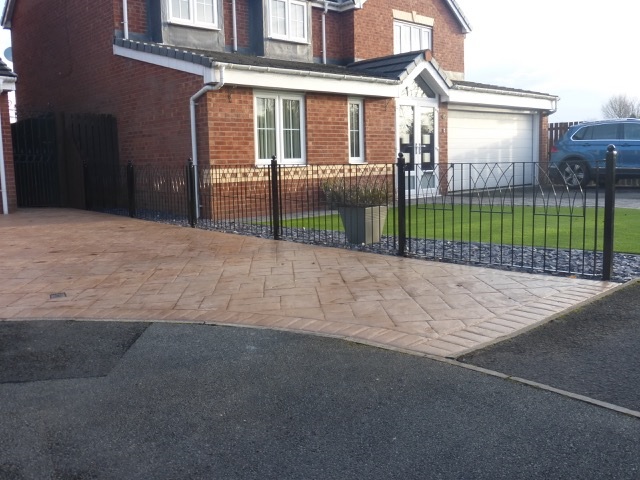 Abbey wrought iron fencing panels secures driveway