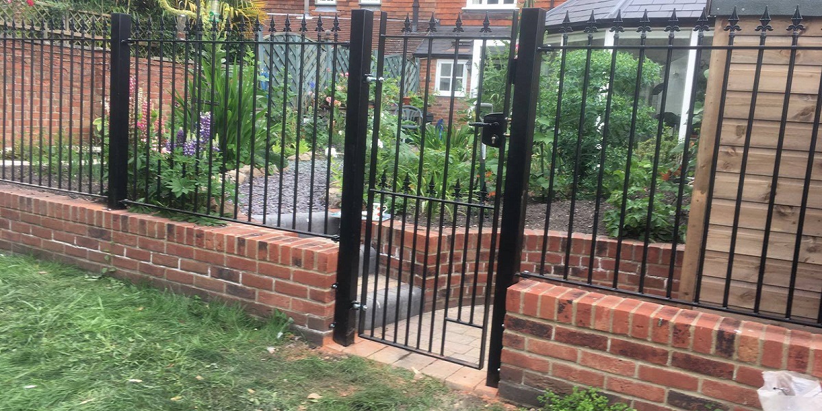 Wrought iron fencing and gate secures rear garden