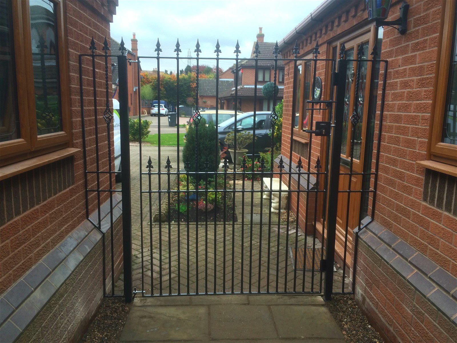 Bespoke side gate and made to measure side panels with fleur de lys finials