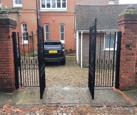 Bespoke bi folding metal gates with an arch top