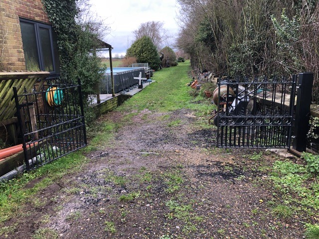 Talisman bespoke bi folding gates mounted to metal posts